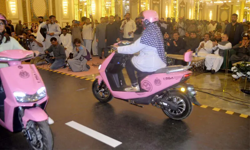 women ride pink scooties at a programme held in Hyderabad on Saturday.—Dawn women ride pink scooties at a programme held in Hyderabad on Saturday.—Dawn