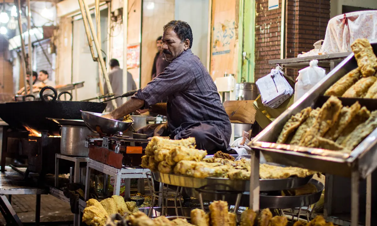 Fish coated with gram flour being prepared by a vendor. — Muhammad Umar/File Fish coated with gram flour being prepared by a vendor. — Muhammad Umar/File