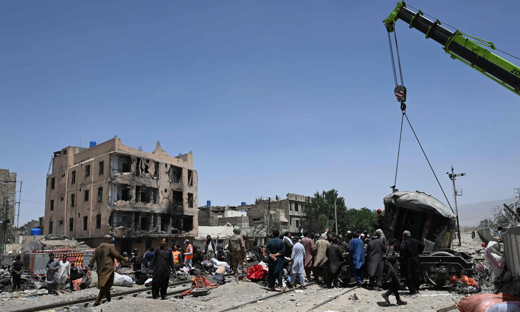 A crane lifts a carriage at the site after an explosion that targeted a train in Quetta on May 24, 2026. — AFP A crane lifts a carriage at the site after an explosion that targeted a train in Quetta on May 24, 2026. — AFP