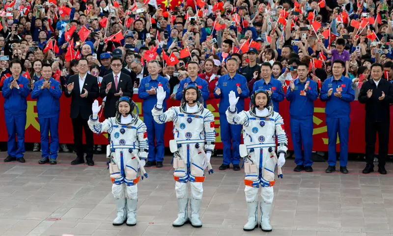 Astronauts Zhu Yangzhu, Zhang Zhiyuan, and Lai Ka-ying wave during a see-off ceremony at the Jiuquan Satellite Launch Centre.&mdash;Reuters