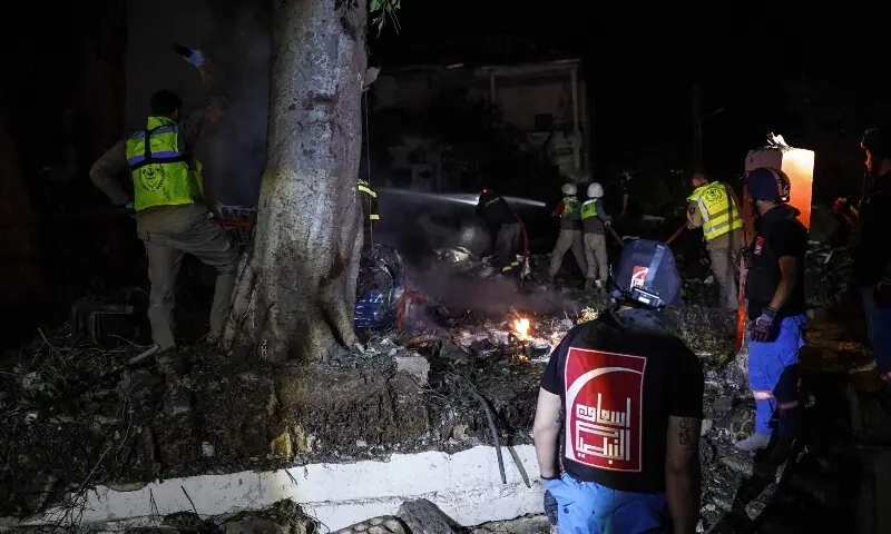 Emergency personnel work to extinguish a fire at a civil defence centre following an Israeli airstrike in the southern city of Nabatieh overnight into on May 24, 2026. &mdash;AFP