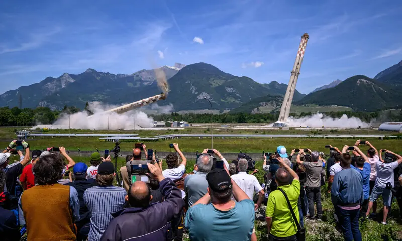 Attendees watch the controlled demolition by explosion of the two 100-metre-high chimneys of a former refinery in Collombey-Muraz, south-western Switzerland last week. Constructed by Eni, the Collombey refinery operated from 1963 to late March 2015, closing after more than 50 years under Tamoil ownership.—AFP Attendees watch the controlled demolition by explosion of the two 100-metre-high chimneys of a former refinery in Collombey-Muraz, south-western Switzerland last week. Constructed by Eni, the Collombey refinery operated from 1963 to late March 2015, closing after more than 50 years under Tamoil ownership.—AFP