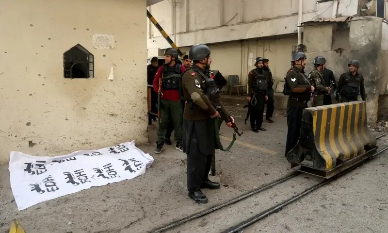 Paramilitary soldiers stand near a body covered with a sheet, after suicide bombers targeted the Federal Constabulary headquarters in Peshawar on November 24, 2025. — Reuters Paramilitary soldiers stand near a body covered with a sheet, after suicide bombers targeted the Federal Constabulary headquarters in Peshawar on November 24, 2025. — Reuters