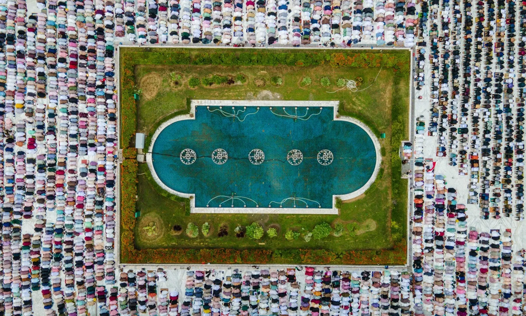 This aerial picture shows Muslim worshippers offering Eid al-Adha prayers at Baiturrahman Grand Mosque in Banda Aceh on May 27. — AFP