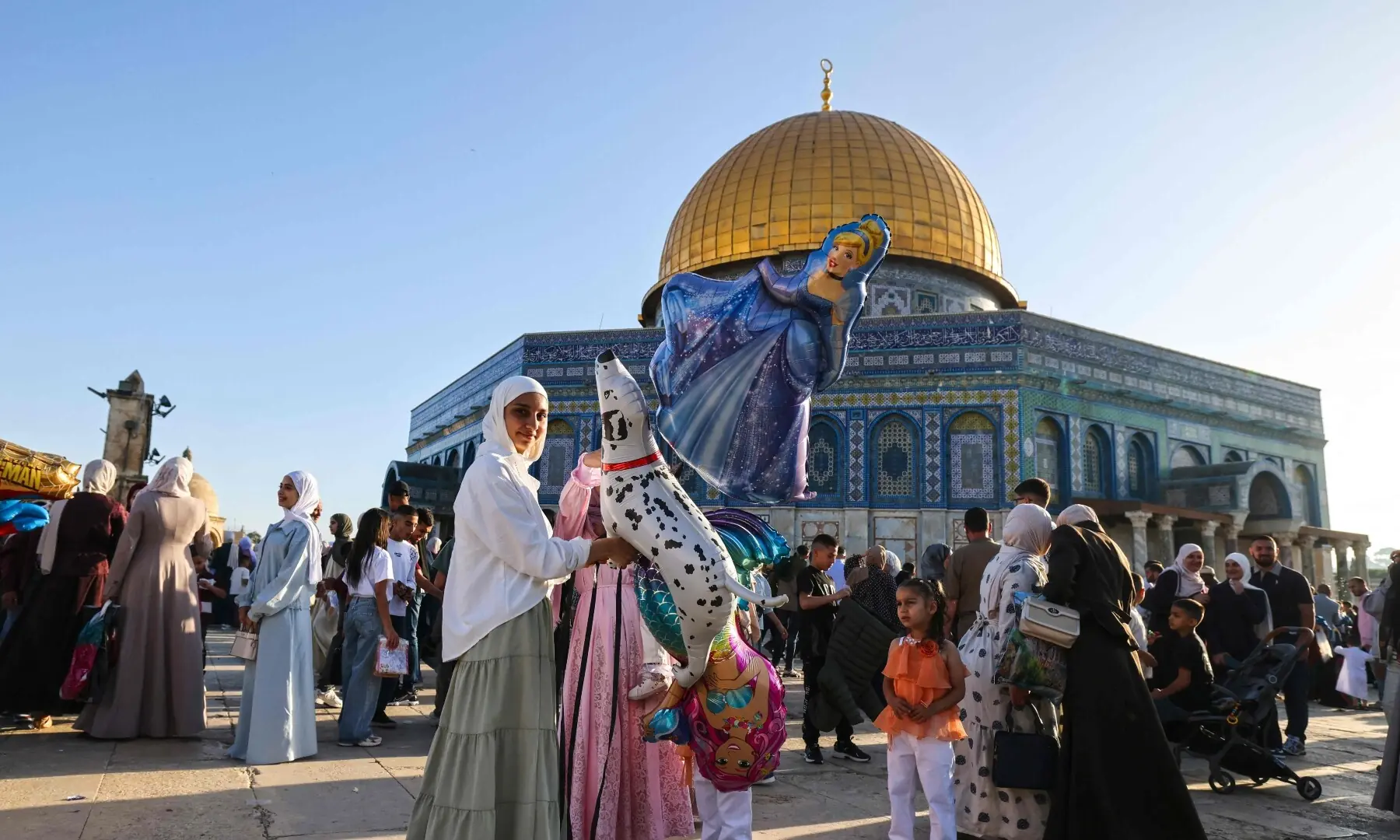 Muslim devotees with their children gather at the Al-Aqsa Mosque compound in Jerusalem on May 27, 2026, to mark the start of Eid al-Adha, the Feast of Sacrifice. — AFP