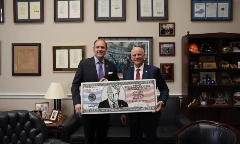 A photo of US Congressman Andy Barr (L) and US Treasurer Brandon Beach holding a rendering of a $250 bill with US President Donald Trump's likeness from January 9, 2026. &mdash; Facebook/Congressman Andy Barr/File