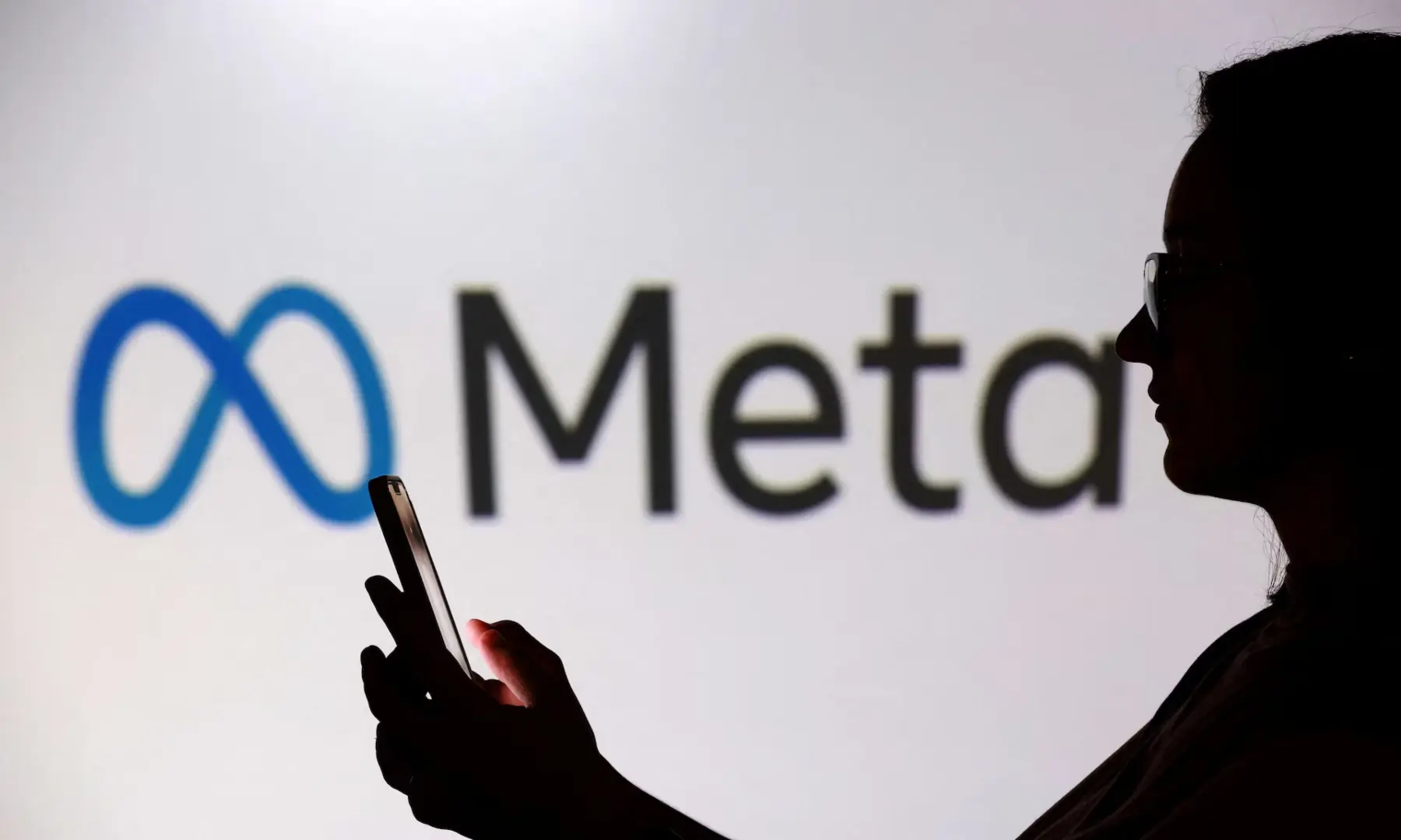 A teenager poses for a photo while holding a smartphone in front of a Meta logo in this illustration taken on Sept 11, 2025. — Reuters/File A teenager poses for a photo while holding a smartphone in front of a Meta logo in this illustration taken on Sept 11, 2025. — Reuters/File