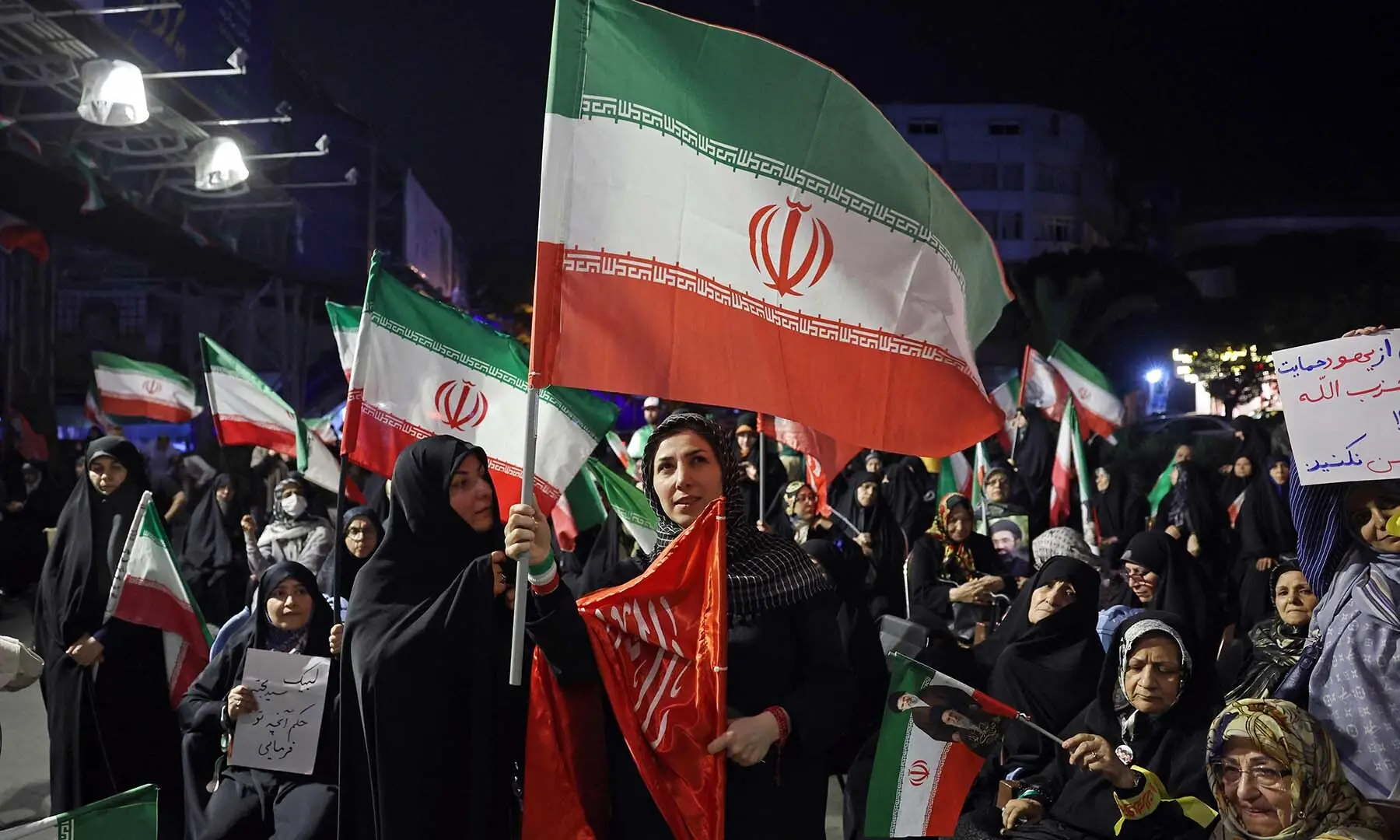 Women wave Iran&rsquo;s national flags during an anti-US and Israel protest in Tehran, Iran on May 29, 2026. &mdash; AFP