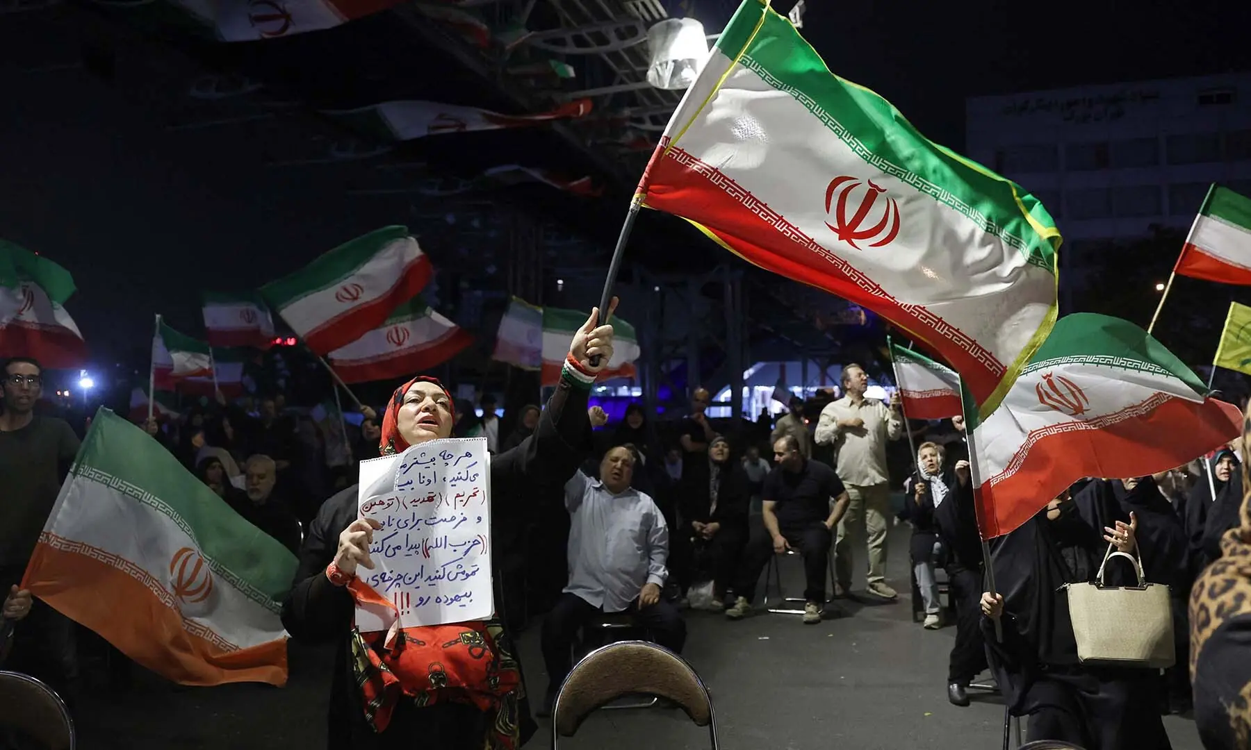 Women wave Iran&rsquo;s national flags during an anti-US and Israel protest in Tehran, Iran on May 29, 2026. &mdash; AFP