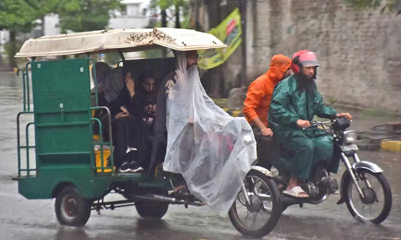 A MOTORCYCLE-rickshaw driver covers himself with a plastic sheet for protection during rain.—Online A MOTORCYCLE-rickshaw driver covers himself with a plastic sheet for protection during rain.—Online