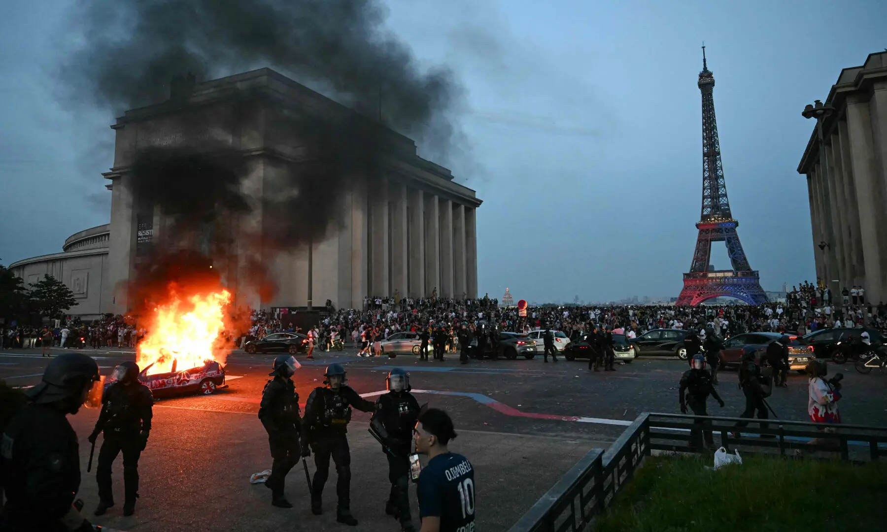 A car is set ablaze as PSG supporters celebrate their team's win in the UEFA Champions League final between Paris Saint-Germain (PSG) and Arsenal FC played in Budapest, at Place du Trocadero opposite the Eiffel Tower in Paris on May 30, 2026. &mdash; AFP