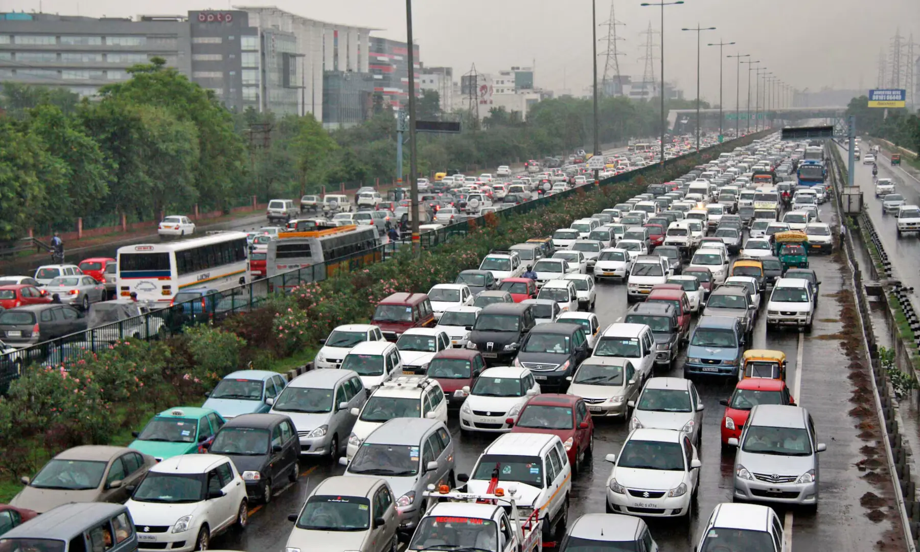 Heavy traffic moves along a busy road as it rains during a power-cut at the toll-gates at Gurgaon on the outskirts of New Delhi on July 31, 2012. &mdash; Reuters/File