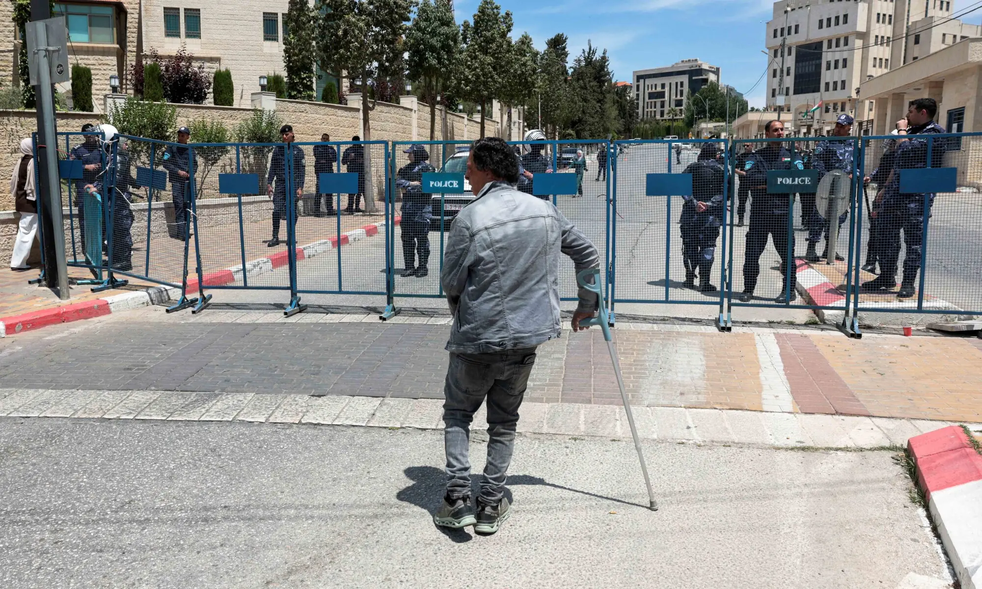 A Palestinian man leaning on a crutch stands in front of a police fence outside the Prime Minister's office during a protest calling on the government to fulfil demands related to prisoners and injured people, in Ramallah, in the Israeli-occupied West Bank, May 31, 2026. — Reuters A Palestinian man leaning on a crutch stands in front of a police fence outside the Prime Minister's office during a protest calling on the government to fulfil demands related to prisoners and injured people, in Ramallah, in the Israeli-occupied West Bank, May 31, 2026. — Reuters