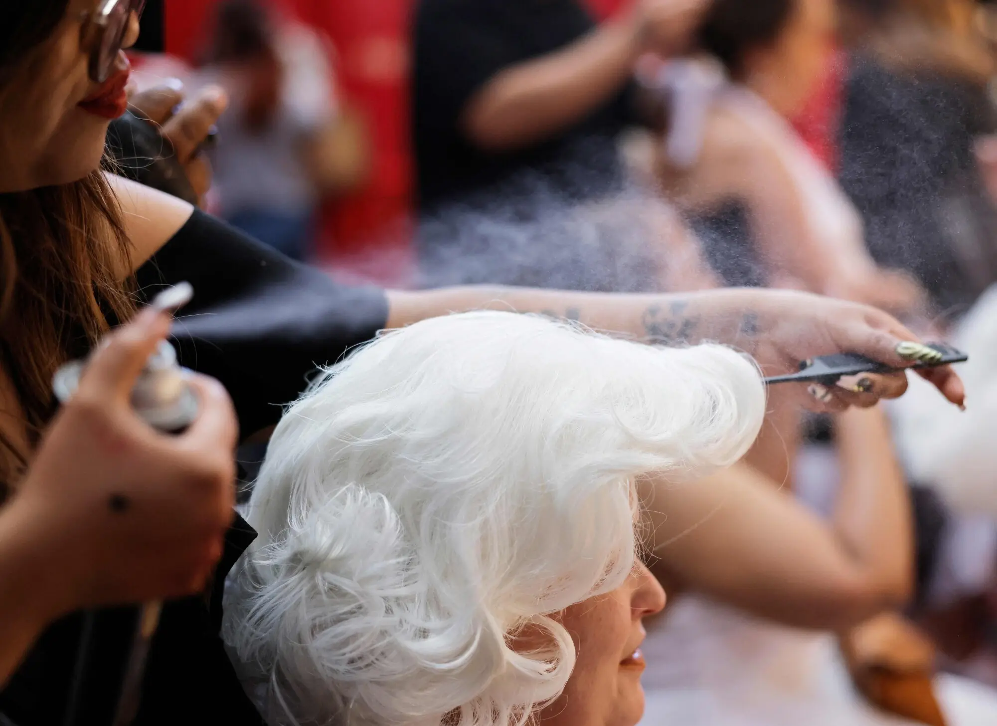 A fan styling a wig resembling Monroe’s platinum blonde hair. Photo: AFP