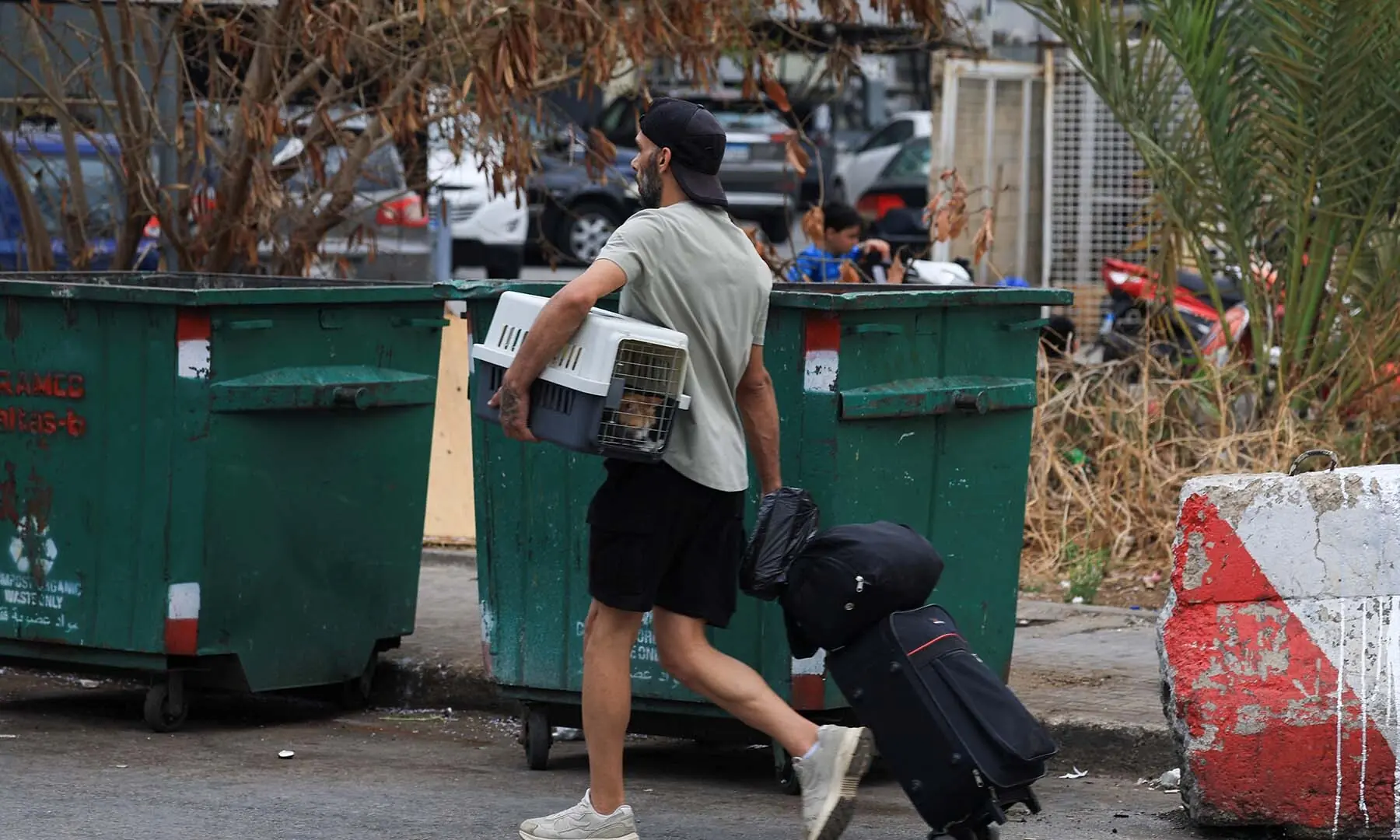 A man with luggage and a cat in a carrier walks, as people make their way while they flee the southern suburbs of Beirut, Lebanon, after Israeli Prime Minister Benjamin Netanyahu ordered the military to attack targets in the suburbs on June 1, 2026. &mdash; Reuters