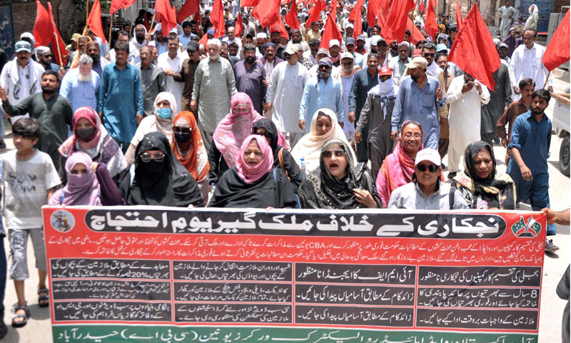 POWER utility workers hold a demonstration after taking out a rally in Hyderabad on Tuesday.&mdash;Dawn