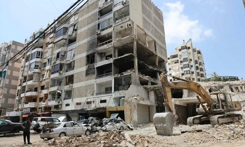 A man speaks on a mobile phone while standing near a destroyed building at a neighbourhood in Beirut&rsquo;s southern suburbs on June 2, 2026. &mdash;AFP 