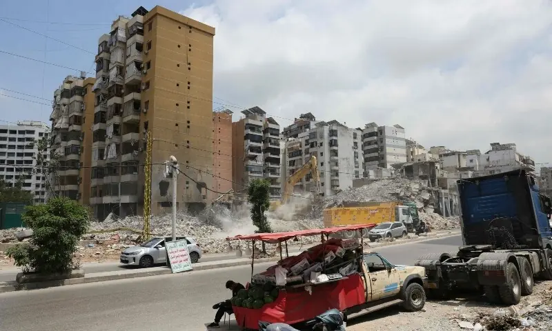  A street vendor waits for customers to buy watermelons opposite a destroyed building at a neighbourhood in Beirut&rsquo;s southern suburbs on June 2, 2026. &mdash;AFP 