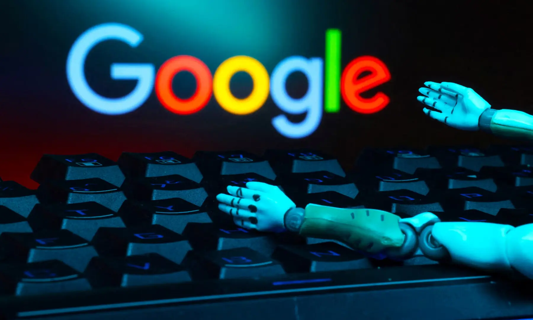 The Google logo, a keyboard, and robot hands are seen in this illustration taken on Jan 27, 2025. &mdash; Reuters/File