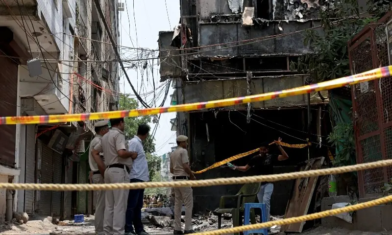 Police officers stand at the site a day after a fire at a hotel in New Delhi, India, on June 4, 2026. &mdash; Reuters