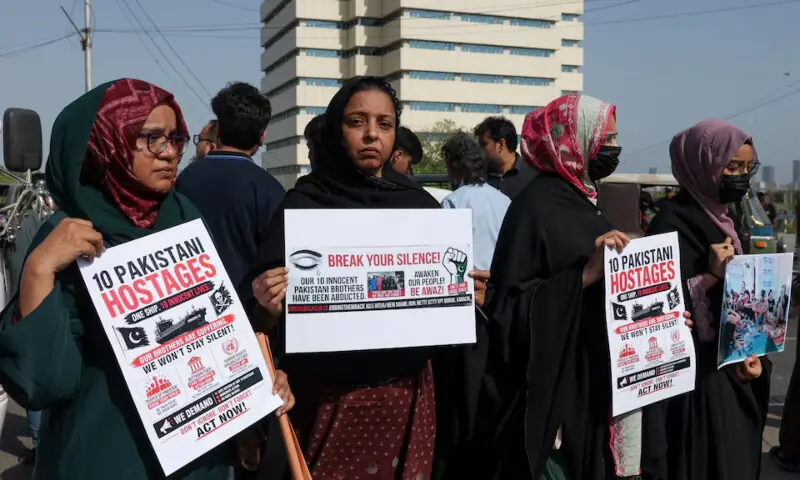  Families of the Pakistani hostage crew members of an oil tanker that was hijacked by pirates off the coast of Somalia, hold placards during a protest, calling on the government to take immediate action for the safe return of their loved ones, in Karachi on May 13, 2026. &mdash; Reuters/File 
