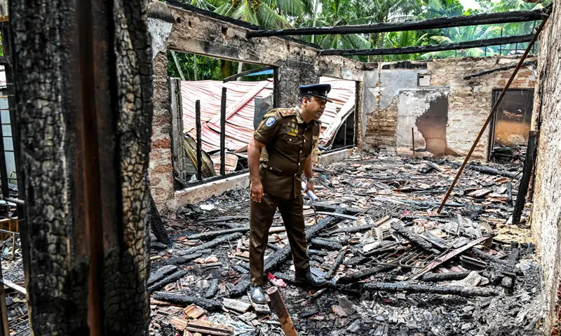 A POLICE official inspects the destroyed house a day after the incident.&mdash;AFP