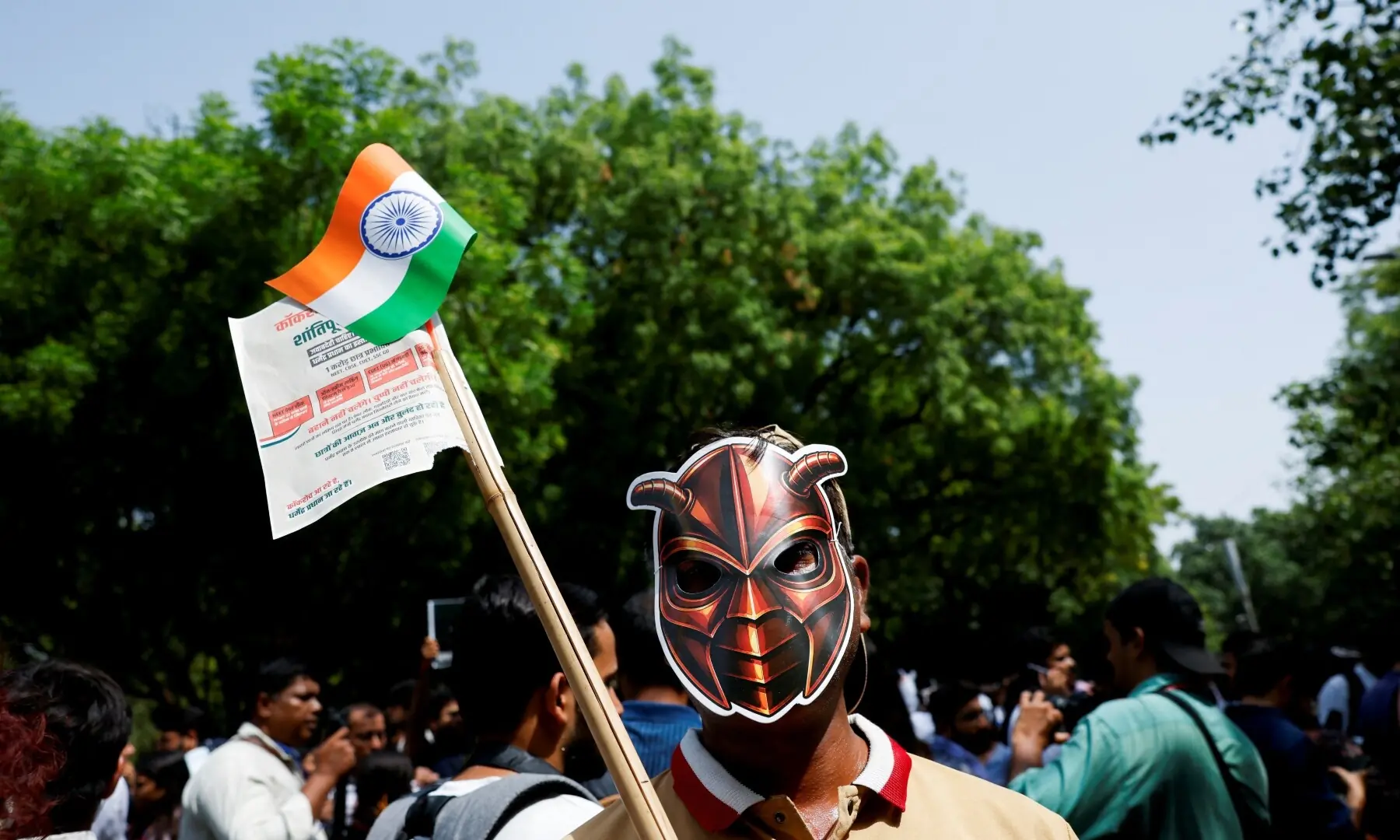 A person wears a cockroach themed mask, as supporters of the Cockroach Janta Party (CJP) await the arrival of Abhijeet Dipke, head of the CJP, on the day of a sit-in protest demanding the resignation of Indian Education Minister Dharmendra Pradhan, in New Delhi, India on June 6, 2026. —Reuters