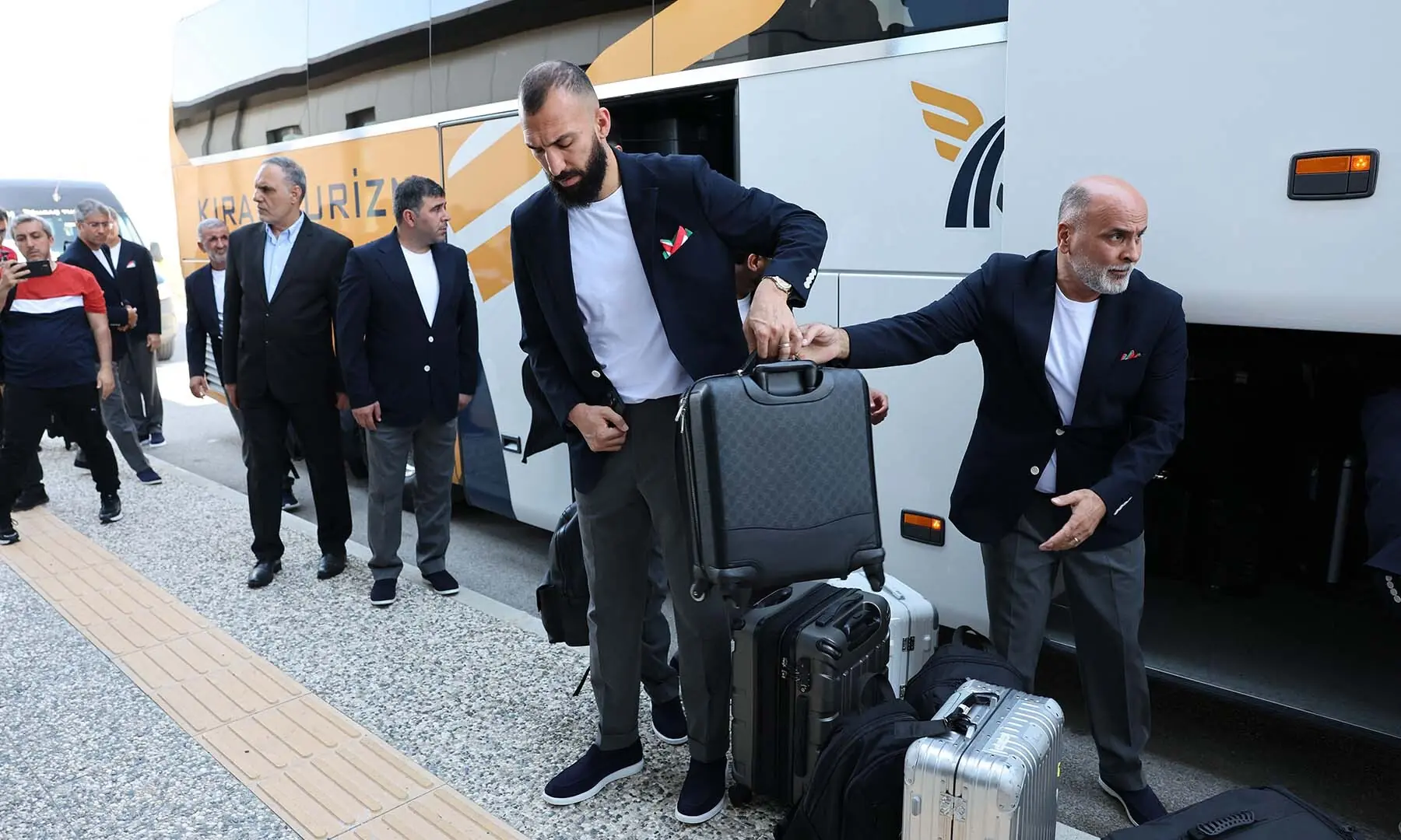 Midfielder Roozbeh Cheshmi (C) descends from a bus as the Iranian national football team arrives at Antalya Airport in Antalya, Turkiye on June 6, 2026, for their departure to Mexico ahead of the FIFA 2026 World Cup. &mdash; AFP