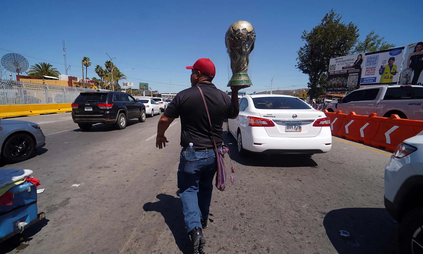 A street vendor holds a reproduction of the FIFA World Cup Trophy near the San Ysidro Port of Entry in Tijuana, Mexico on May 30, 2026, as the Iranian national football team is set to establish its base camp there for the 2026 FIFA World Cup. — Reuters/File