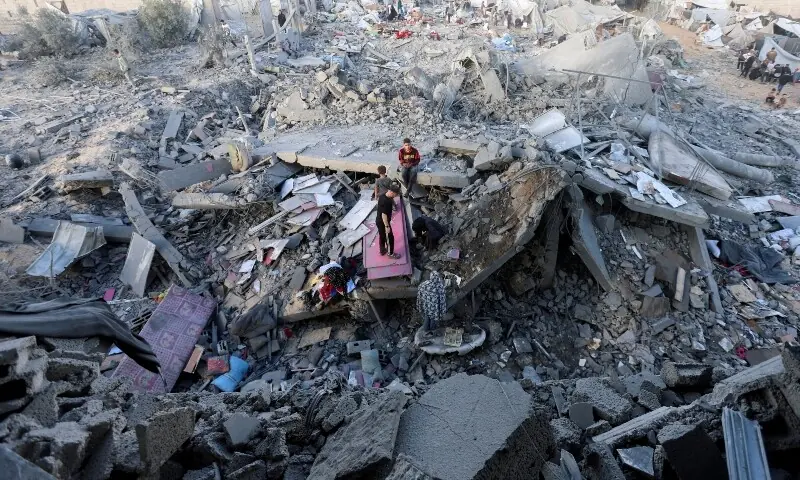 Palestinians inspect the site of an Israeli strike on a house whose residents were warned to evacuate before the attack, near a tent camp sheltering displaced people that was damaged in the strike, in Khan Younis in the southern Gaza Strip June 7. — Reuters Palestinians inspect the site of an Israeli strike on a house whose residents were warned to evacuate before the attack, near a tent camp sheltering displaced people that was damaged in the strike, in Khan Younis in the southern Gaza Strip June 7. — Reuters