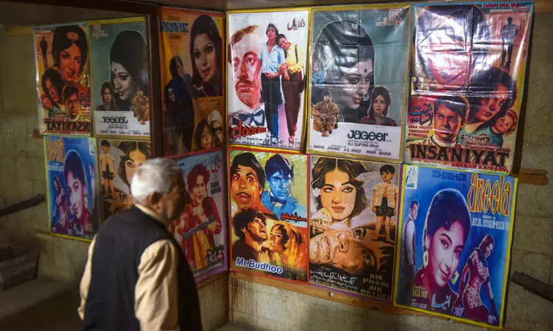 A man looks at the posters displayed at Reno Cinema.&mdash;Fahim Siddiqi / White Star