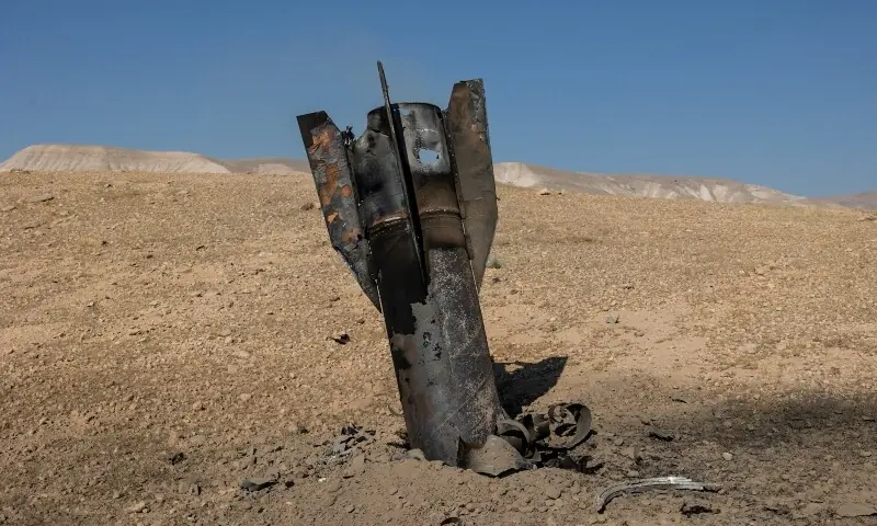 Part of a missile protrudes from the ground, from the ground, following strikes from Iran, in the central Israeli-occupied West Bank, June 8, 2026. &mdash;Reuters