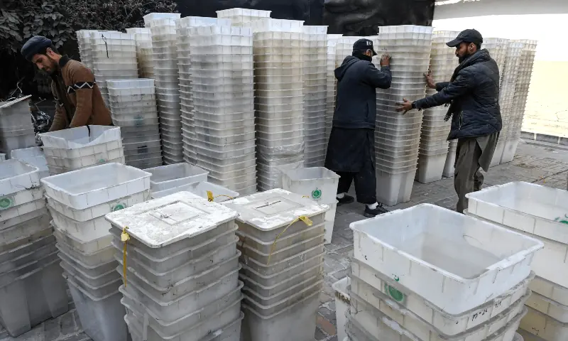 Workers prepare ballot boxes before sending it to different polling stations for the upcoming general elections, at the Election Commission office in Peshawar on February 4, 2024. &mdash; AFP/File