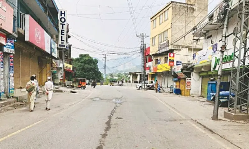 People walk on an otherwise busy artery in Muzaffarabad, which wore a deserted look amid a shutterdown and wheeljam strike on May 10, 2024. — Photo by Tariq Naqash/File People walk on an otherwise busy artery in Muzaffarabad, which wore a deserted look amid a shutterdown and wheeljam strike on May 10, 2024. — Photo by Tariq Naqash/File