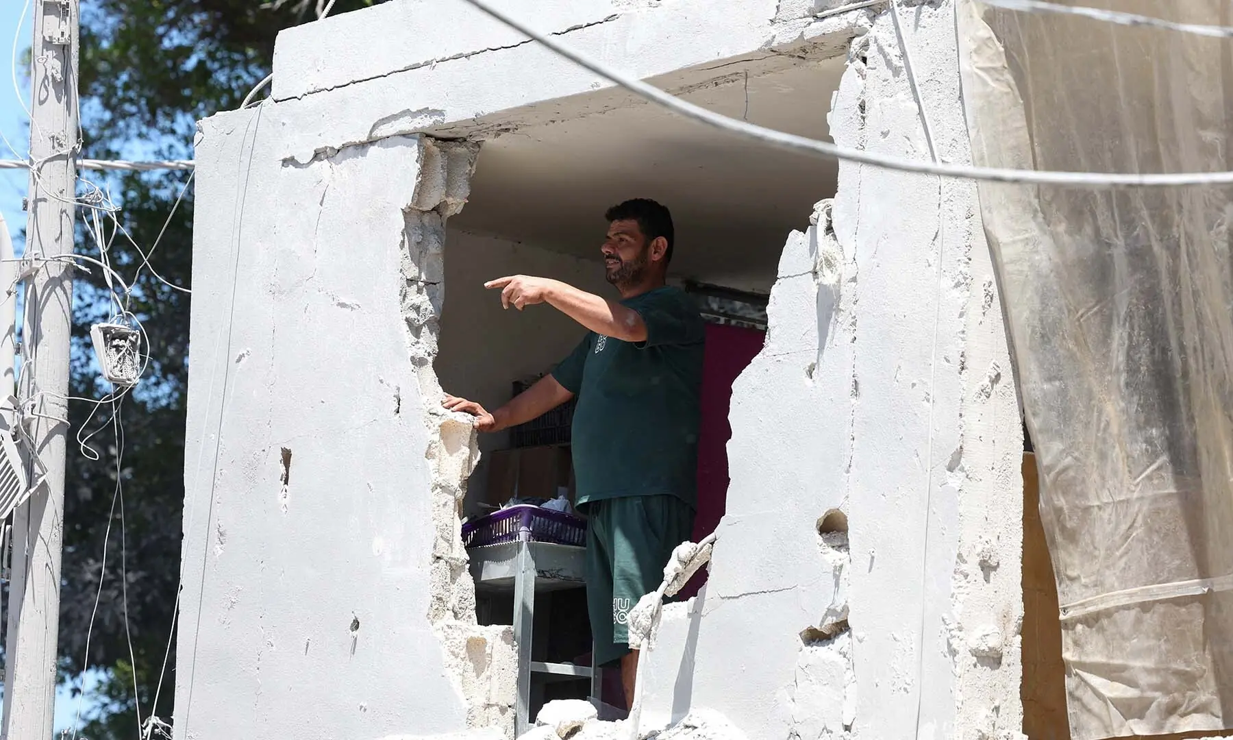 A man inspects damage at the site an Israeli strike in Tyre, Lebanon on June 12, 2026. &mdash; Reuters
