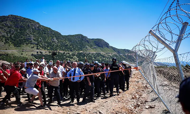 Protesters who say their land has been taken unjustly, tear down the fence where a tourist resort is to be built on Albania’s Adriatic coast.—Reuters Protesters who say their land has been taken unjustly, tear down the fence where a tourist resort is to be built on Albania’s Adriatic coast.—Reuters