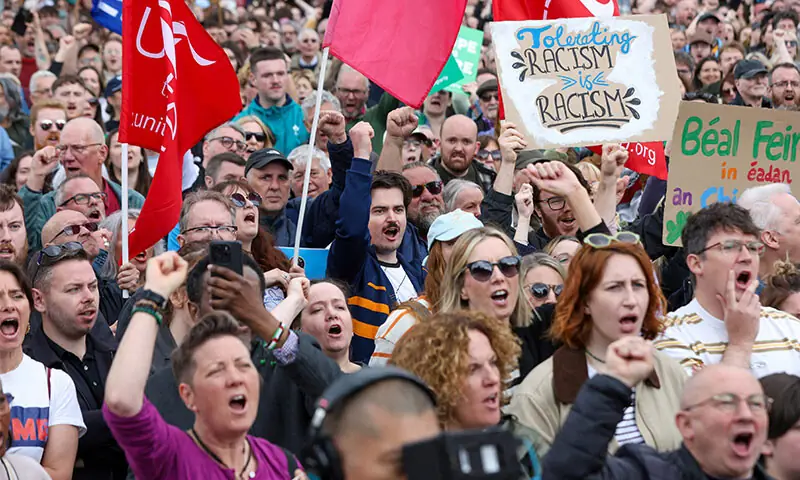ACTIVISTS turn out for a demonstration against racism, after several nights of disorder in Belfast.—AFP ACTIVISTS turn out for a demonstration against racism, after several nights of disorder in Belfast.—AFP