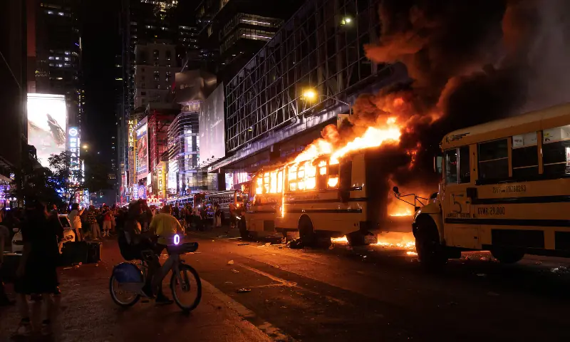 Revellers and fans celebrating the New York Knicks' win over the San Antonio Spurs and World Cup festivities watch as a city shuttle bus catches fire outside the Port Authority Bus Terminal in New York, US on June 14, 2026. — Reuters Revellers and fans celebrating the New York Knicks' win over the San Antonio Spurs and World Cup festivities watch as a city shuttle bus catches fire outside the Port Authority Bus Terminal in New York, US on June 14, 2026. — Reuters