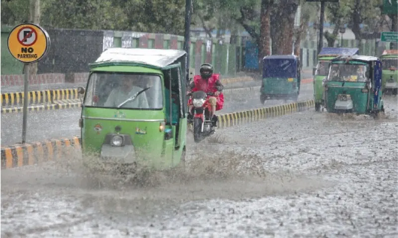 Rickshaws pass through the rainwater accumulated on Saddar Road in Peshawar. — White Star/File Rickshaws pass through the rainwater accumulated on Saddar Road in Peshawar. — White Star/File