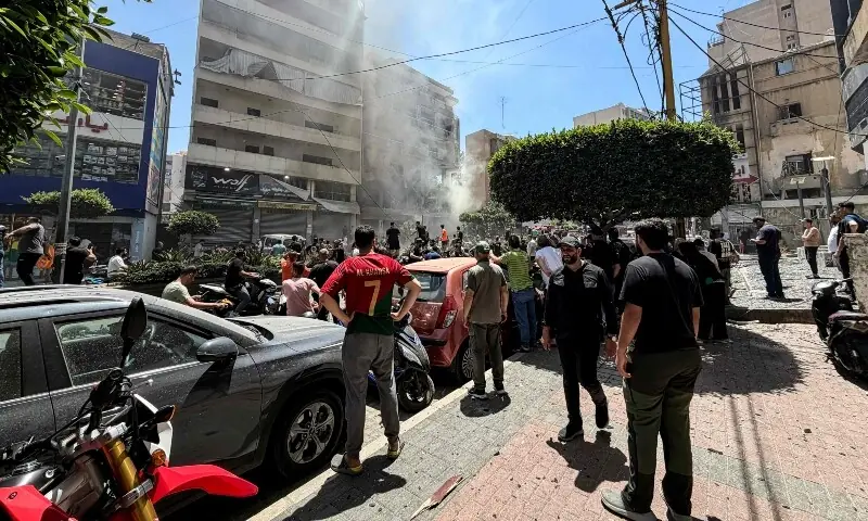 People gather at the site of an Israeli airstrike that targeted a building in Beirut&rsquo;s southern suburbs on June 14. &mdash; AFP