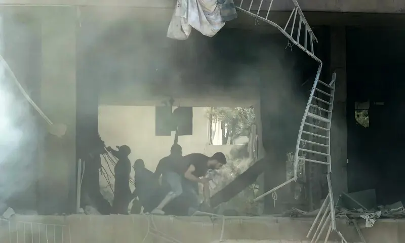 People look for survivors at the site of an Israeli airstrike that targeted a building in Beirut&rsquo;s southern suburbs on June 14. &mdash; AFP