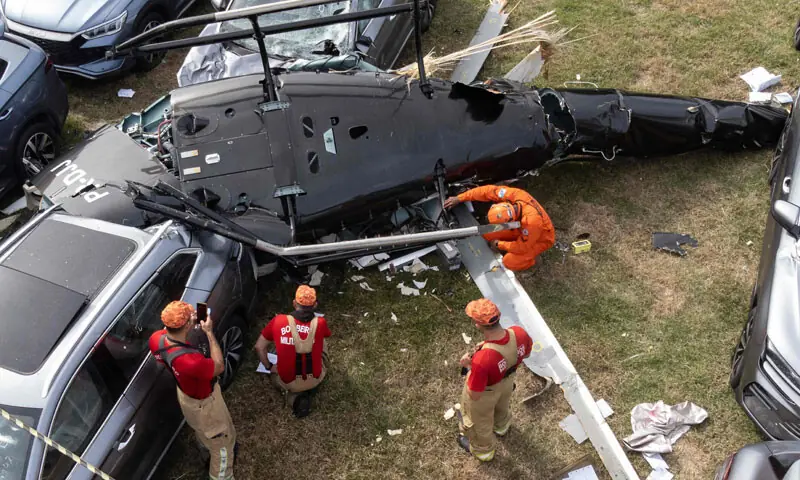 FIREFIGHTERS reach one of the helicopter crash sites in Rio de Janeiro, Brazil.—AFP FIREFIGHTERS reach one of the helicopter crash sites in Rio de Janeiro, Brazil.—AFP