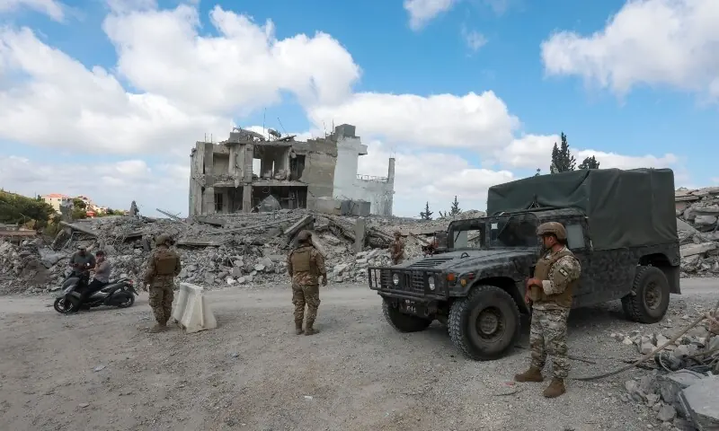  Members of the Lebanese army stand guard next to a transport vehicle, as people make their way, back to their homes, following a peace deal between the United States and Iran, in Bir Al-Salasil, Tyre district, southern Lebanon, June 15, 2026. &mdash;Reuters 