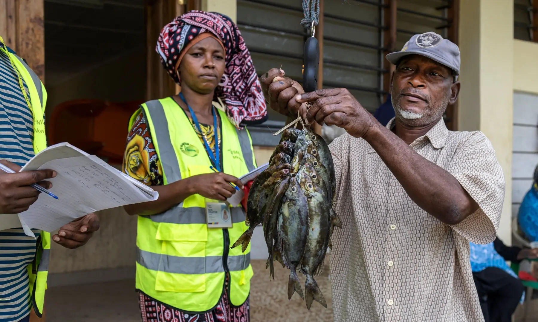 A fisherman delivers his catch for data capture by officials of the local Beach Management Unit (BMU), conserving mangrove and coral have helped the island become a world-renowned eco-tourism destination in Wasini island on June 14, 2026. —AFP