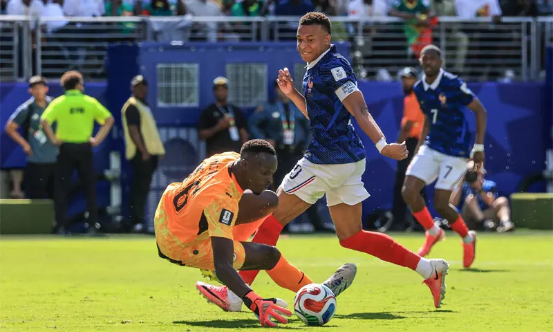 Kylian Mbappe scores his team&rsquo;s first goal past goalkeeper Edouard Mendy during the match with Senegal.&mdash;AFP
