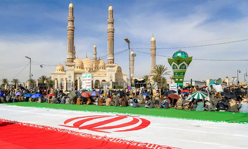 SANAA: Supporters of the Houthi rebels gather next to a giant Iranian flag, unfurled at a mass rally.&mdash;AFP