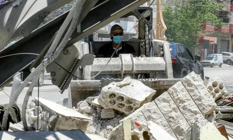  A worker pilots a small excavator to remove the rubble of a destroyed building in the village of Deir Qanoun al-Nahr in southern Lebanon on June 16, 2026. &mdash;AFP 