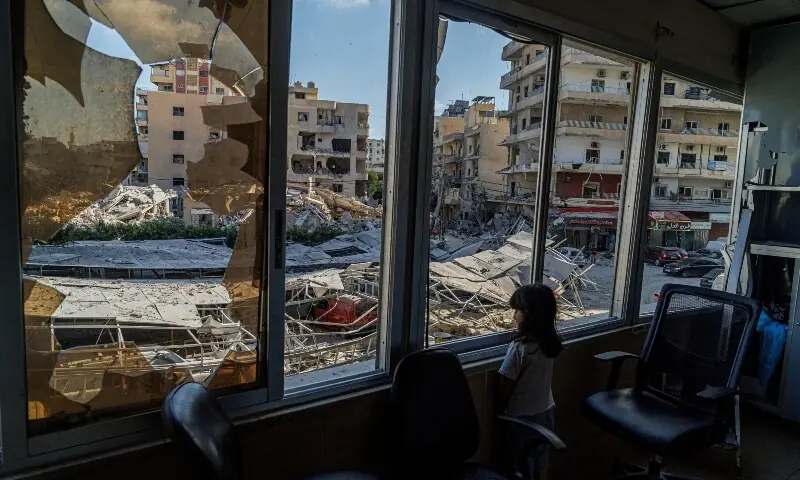  A displaced girl stands at the broken window of Jabal Amel hospital where she has taken shelter with her family, overlooking buildings damaged by Israeli strikes, following a deal between the US and Iran, in Tyre, southern Lebanon, June 16, 2026. &mdash;Reuters 