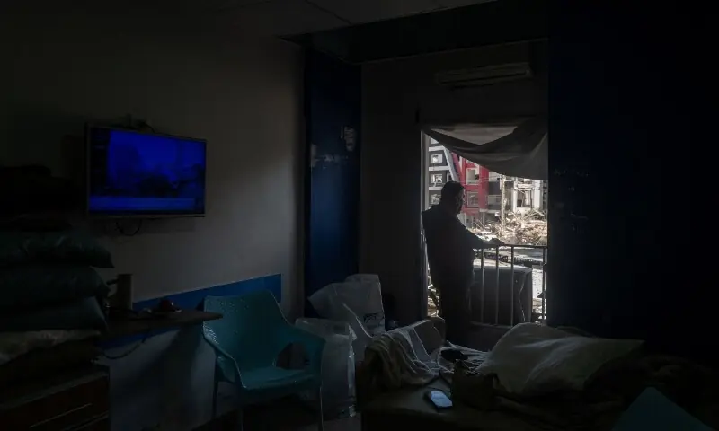  Youssef Fares, 90, whose home of more than 70 years, was reportedly damaged by an Israeli airstrike, stands at the window of a hospital room where he has taken shelter, overlooking buildings damaged by Israeli strikes, following a deal between the US and Iran, in Tyre, southern Lebanon, June 16, 2026. &mdash;Reuters 