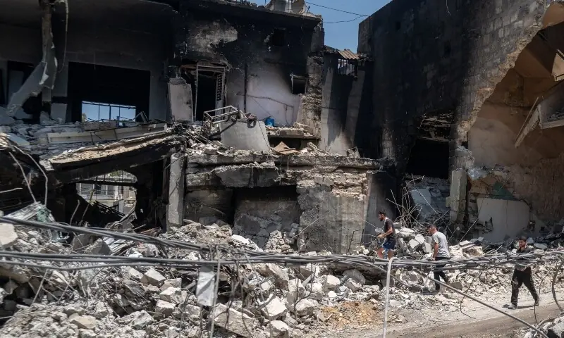  Men walk among the rubble of shops damaged by Israeli strikes in Nabatieh, Lebanon, June 17, 2026. &mdash;Reuters 